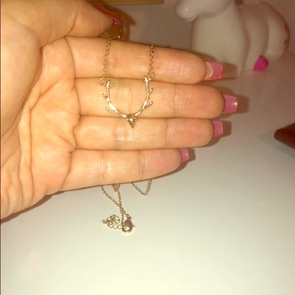 A pretty gold plated deer head necklace
